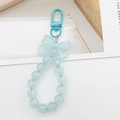 Detailed view of light blue beaded keychain with a matching bow and lobster clasp - Blue
