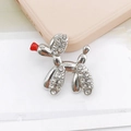 Macro shot of a silver balloon dog charm with sparkling rhinestones and a red nose detail - Silver Balloon Dog with Red Nose