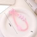 Cinturino per telefono in perle acriliche rosa con fiocco e cuori, 147mm e 18g - Rosa