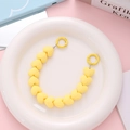 Detail view of matte yellow heart-shaped beaded charm with matching spring ring clasp - Yellow (K1870)