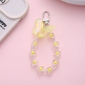 Detail of yellow butterfly charm and floral beaded strap with silver clasp - Yellow