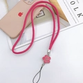 Detail of woven pink PU leather phone lanyard featuring a floral camellia pendant - Rose Red