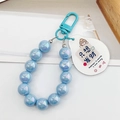 Light blue beaded keychain with acrylic pendant featuring Happiness is wealth text - Blue (Only Want Wealth)