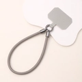 Detailed view of grey leather phone wrist strap with gunmetal clasps and insert card - Gray