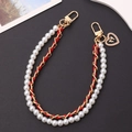 Detail of red leather woven chain with white pearls and heart bow charm pendant - Red
