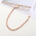 Detail of light gold metal chain woven with soft pink leather and swivel lobster clasps - Pink