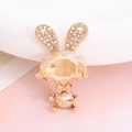 Macro shot of cute bunny jewelry accessory with champagne crystal and gold bow detail - Rhinestone Rabbit (Champagne)