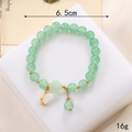 Elegant pale green beaded bracelet with a white butterfly charm and gold accents - Green Jade Glass White Butterfly (K3631)