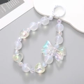 Iridescent beaded phone charm with a butterfly bow and heart elements on a white ring - K366 Mermaid Bow Pendant (White) / Charm