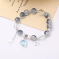 Elegant beaded crystal bracelet with blue gradient moonstone and celestial charms - Shell Crackle Bead Dark Blue (K4433)