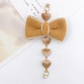 Detail of plush bow with four hanging heart charms on a golden link chain accessory - Khaki