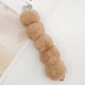 Close-up of a plush faux rabbit fur hair clip with brown pom poms and silver metal grip - 5 Pom Pom Strap (Strap) / Khaki (K733)