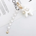 Detail of white balloon dog pendant with gradient pearls and golden lobster clasp - White