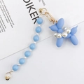 Detail of light blue matte resin balloon dog charm with pearls and gold lobster clasp - Blue