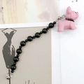 Detail view of pink matte bulldog charm with black beaded strap and metal buckle - Pink