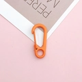 Detail of a bright orange lobster clasp with spring gate mechanism on a pink background - Orange