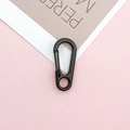 Matte black metal lobster clasp and spring hook for DIY keychains on pink background - Black