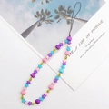 Close-up of candy-colored star and heart beaded phone strap with yellow smiley face bead - Colorful