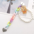 Macro shot of colorful acrylic chain links with white pearls and orange bear charm detail - K864 Acrylic Chain Bear