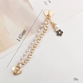 Gold-tone dual chain strap with heart clasp, pearls, and black camellia pendant, 145mm length - White