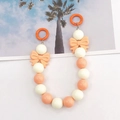 Detail of candy color acrylic beads and matte pink bows on a versatile accessory chain - White + Orange
