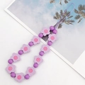 Handmade phone strap featuring purple matte beads and flower accents on white background - Purple