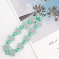 Detail of light green floral beaded phone strap with wooden flower and round beads - Green