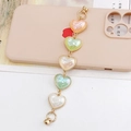 Detail of colorful acrylic heart charms with gold rings for phone case accessories - Multicolor