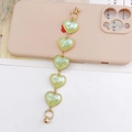 Detail of light green pearlescent heart charms with gold edges for phone case strap - Colorful Green