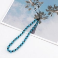 Detail shot of light blue crystal cube beads and black round beads on a phone strap charm - Blue (K1013)