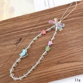 Detail shot of a 155mm handmade beaded phone strap with acrylic heart and star charms - Bowknot Style (K1056AB)
