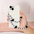 Beaded phone strap with black heart pendant on a wavy cream white iPhone case - Black Heart Artificial Pearl Beaded Phone Chain (K619)