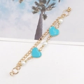 Double-layer gold chain bracelet featuring sky blue enamel hearts and white faux pearls - Magnetic Model / Light Blue