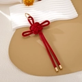 Detalle de nudo chino rojo con cierre dorado sobre un soporte artístico decorativo - Estilo de Cuero con Textura de Bambú (K5991)