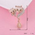 Macro detail of crown fox jewelry charm with cat eye stones and sparkling rhinestones - Cat-Eye Stone Drop Pendant Fox Brooch (D807)
