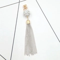 Close-up of golden rhinestone ball charm with delicate silver chain fringe tassels - White (K1490 Screw Buckle Tassel)