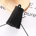 Macro view of a 3cm black faux suede tassel pendant with silver ring for DIY accessories - Black