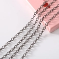 Close-up of four parallel gunmetal gray metal fine chains for DIY jewelry making - Meter / Gun Black Cable Chain