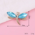 Macro detail of gold dragonfly alloy accessory with blue stones and white crystals - D574 Dragonfly (Gold Base Blue)