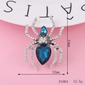 Macro detail of a 44mm silver spider brooch with blue crystals and dimensions shown - D1004 Spider (Silver)