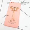Pink phone case with gold butterfly jewelry charm featuring tassels and white gems - D501 Dragonfly Tassel