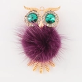 Alloy owl pendant with golden finish, green crystal eyes and purple pom-pom detail - Purple