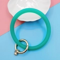 Primer plano de pulsera de silicona verde menta con cierre de anillo de metal dorado - Clásico / Verde