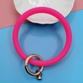 Close-up of rose pink matte silicone ring bracelet with a secure gold metal spring clasp - Rose Red