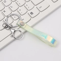 Iridescent laser PVC strap keychain with silver lobster clasp on white keyboard - Yellow