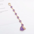 Detail of purple heart and hexagonal charm phone chain with gold metal edges - Purple