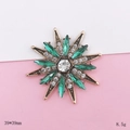 Detailed macro view of vintage sunburst brooch with emerald green crystals, 39x39mm size - Green Star Style (D1948)