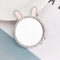 Close-up of cute rabbit ear makeup mirror with sparkling rhinestones and pink details - Rabbit Ears Style / Silver