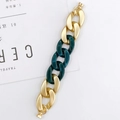 Detail of chunky gold matte metal and dark green resin acrylic chain links with round clasp - Bracelet / Gold + Emerald Green