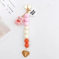 Pink flocked bear keychain with gradient acrylic beads and golden heart-shaped clasp - Pink